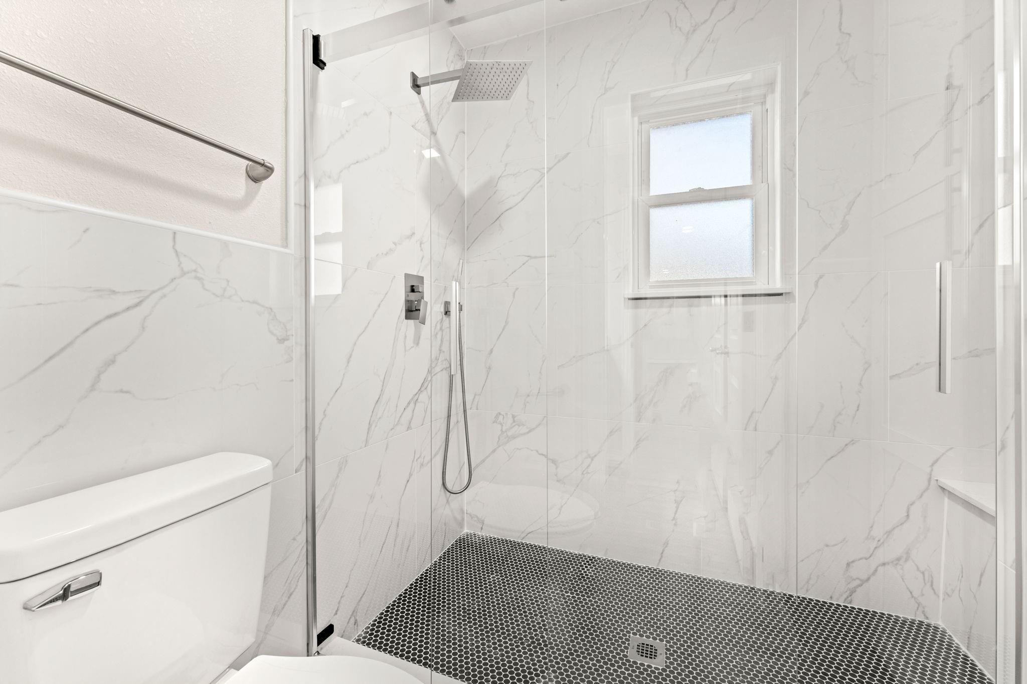 newly remodeled bathroom in Royse City, TX by an expert general contractor featuring a newly installed stand-in shower.